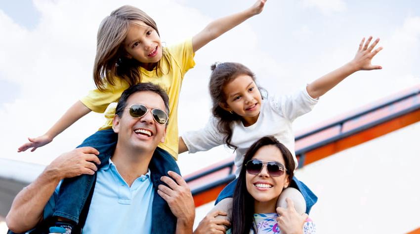 An excited family preps to board an airplane